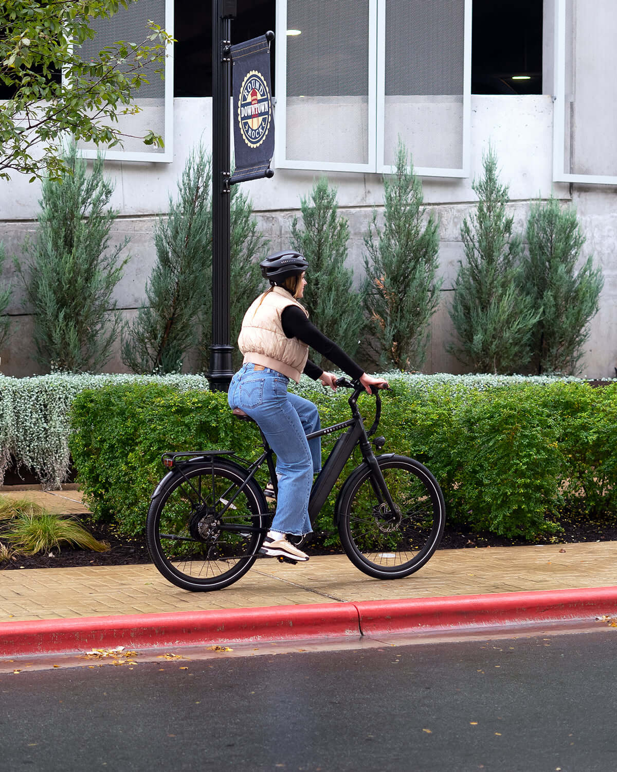 Person riding MOD Berlin 3 electric bike with minimalist European design, featuring dual suspension and powerful torque-sensing system.