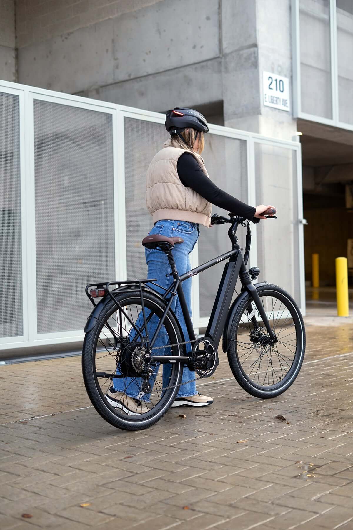 Person riding MOD Berlin 3 electric bike with minimalist European design, featuring powerful torque-sensing system and dual suspension.