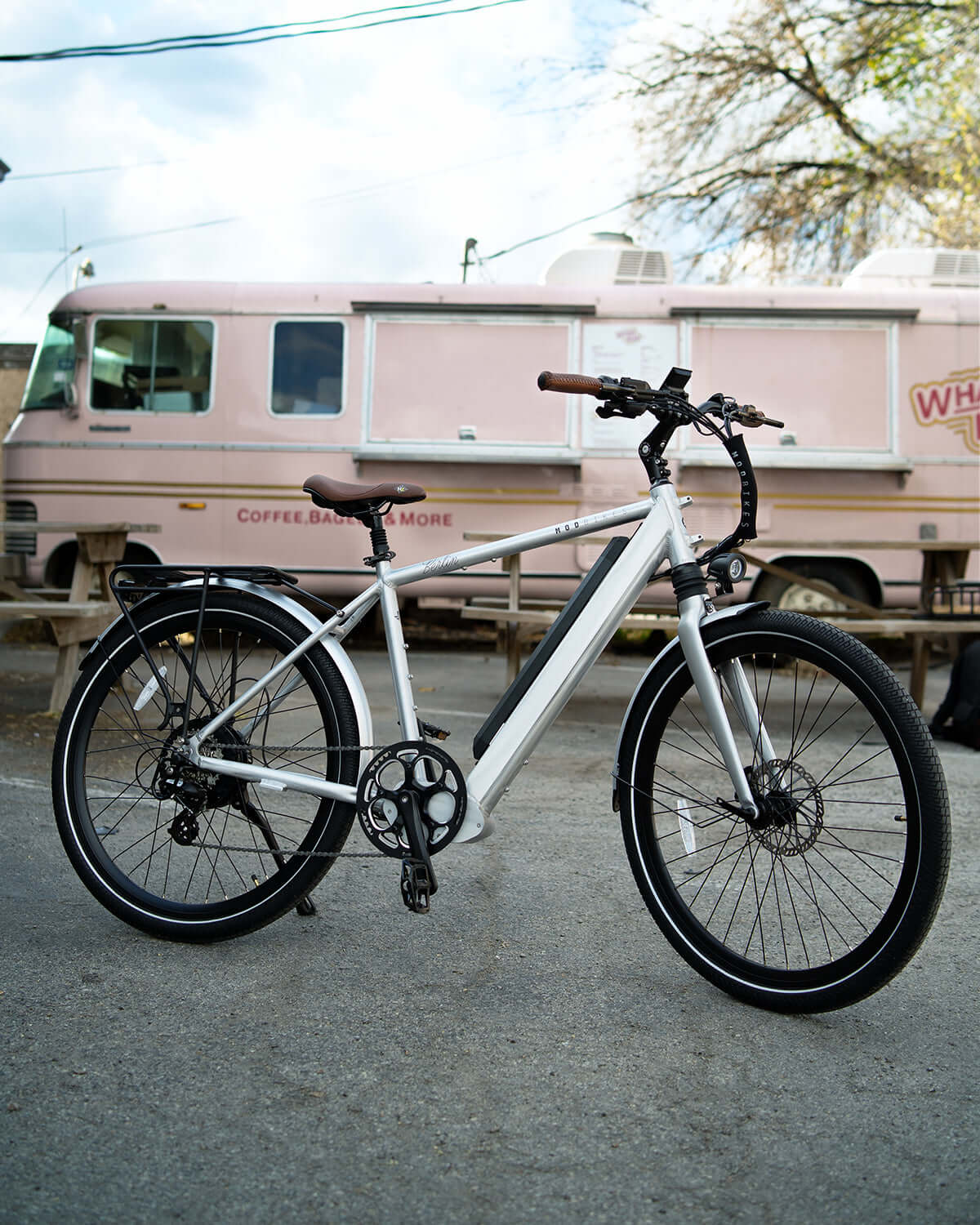 MOD Berlin 3 electric bike with European design, lightweight frame, powerful system, and dual suspension in urban setting.