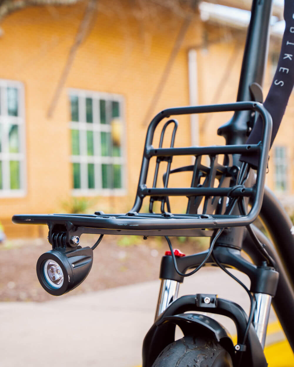 Close-up of MOD CarGo 3 bike's Snap-On rack, showcasing its sturdy design and versatility for hauling passengers or heavy loads.