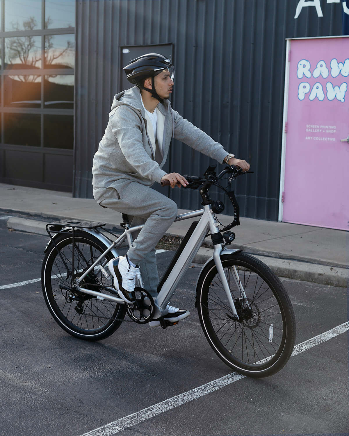 Person riding the MOD Berlin 3 electric bike with minimalist design and dual suspension, perfect for commuters seeking performance.