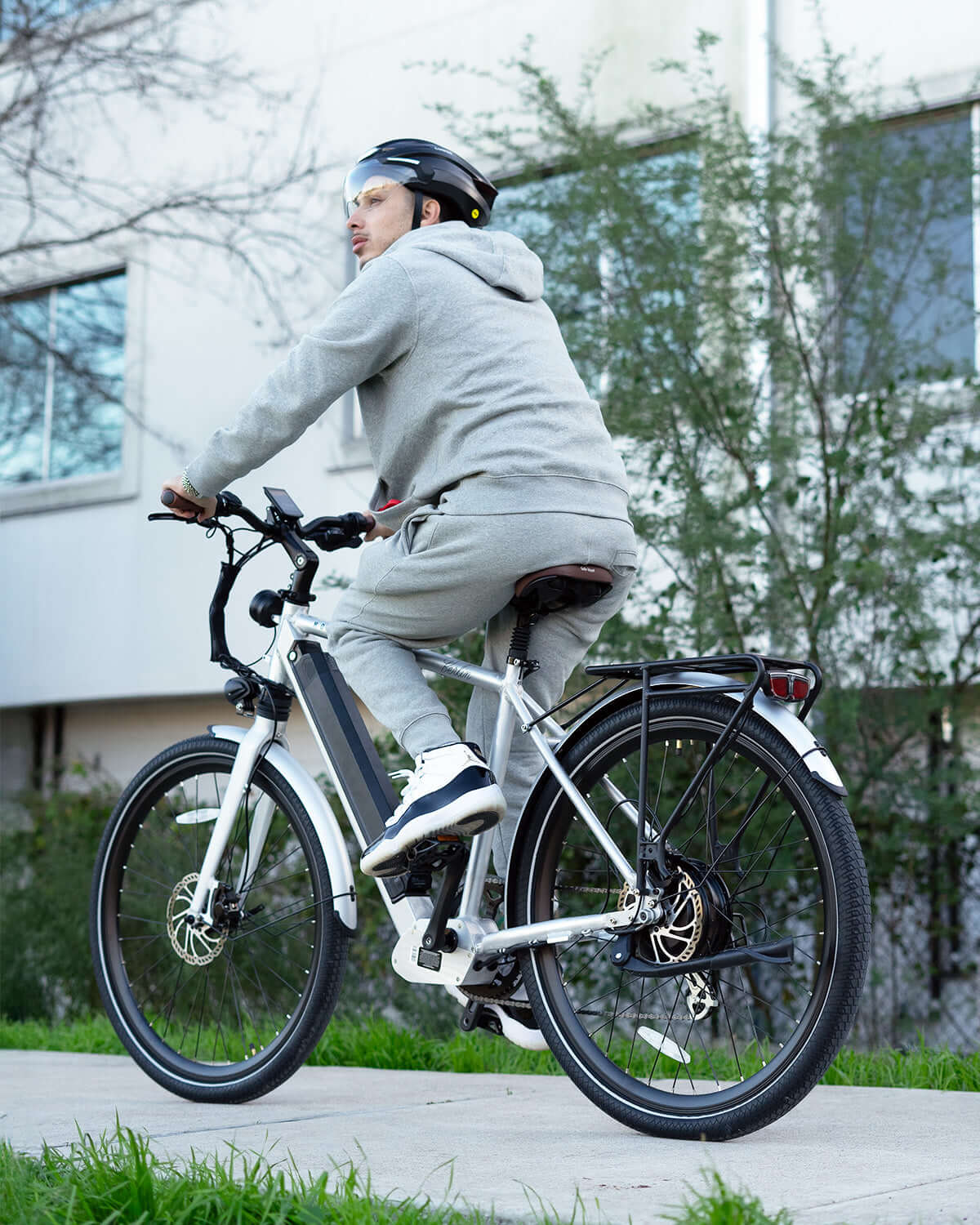 Man riding MOD Berlin 3 electric bike with minimalist European design and dual suspension, ideal for city commuting.