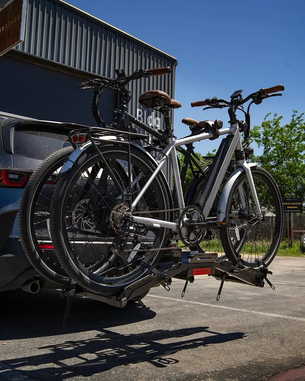 Hollywood Destination E-Bike Rack mounted on a car with two e-bikes, ready for easy loading and unloading, perfect for outdoor adventures.