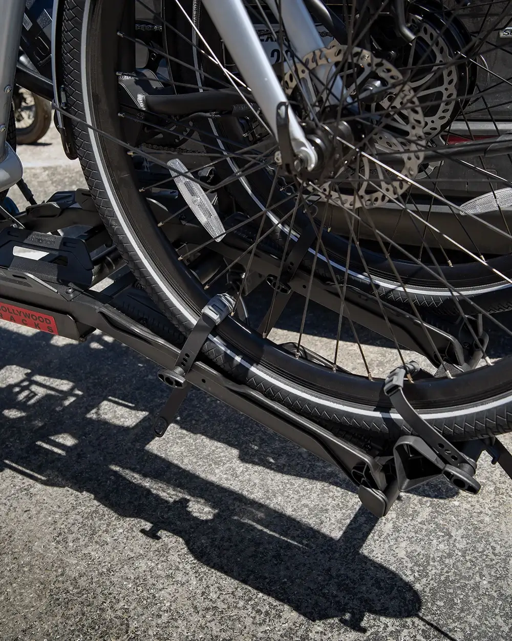 Close-up of Hollywood Destination E-Bike Rack securely holding a bike, showcasing its durable, high-capacity design and aluminum ramp.