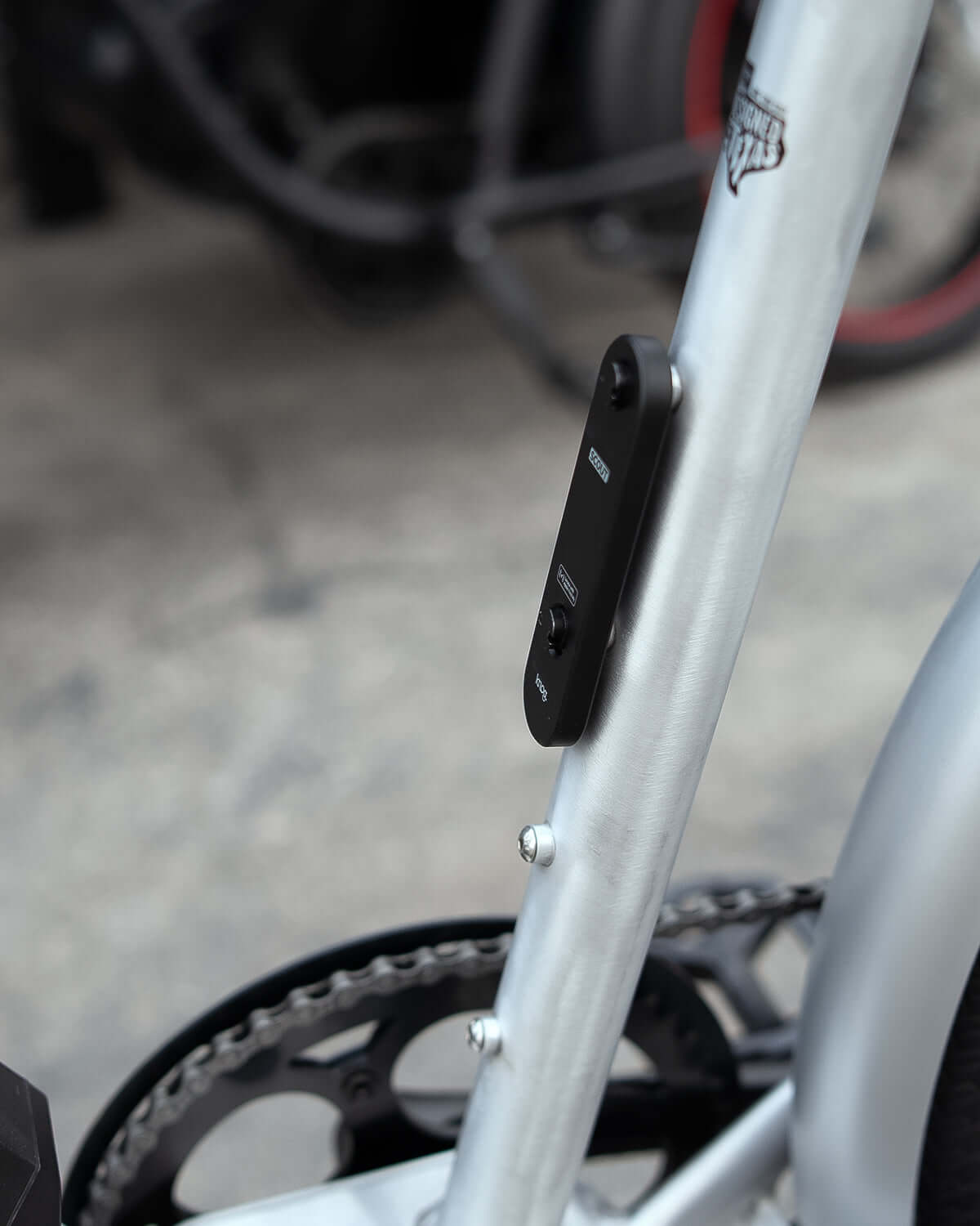 Bike Alarm & Finder mounted on bicycle frame, water-resistant, with discreet design, integrated with Apple's Find My app for security tracking.