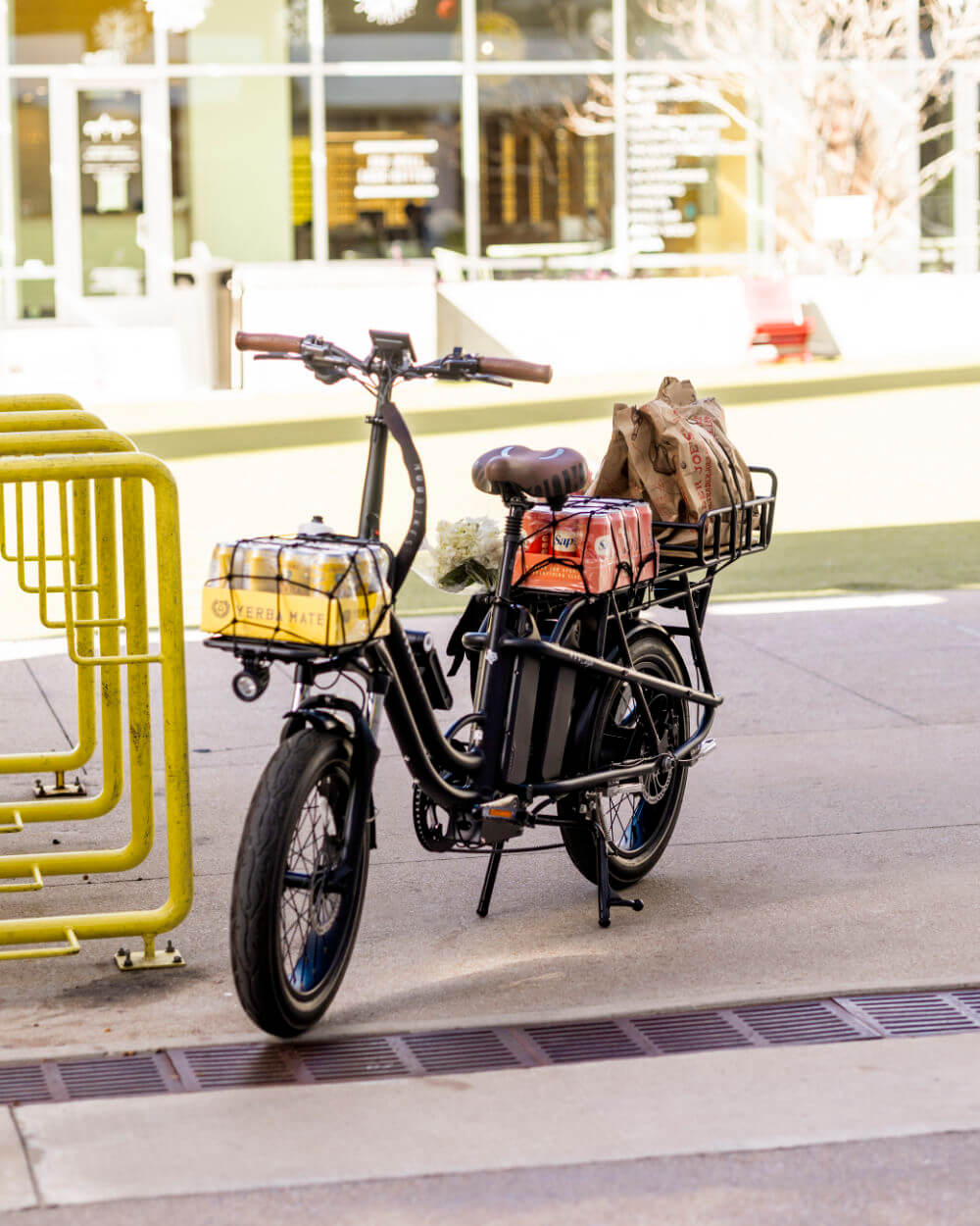 MOD CarGo 3 bike with Snap-On rack and dual battery parked in urban setting, perfect for transporting passengers or heavy loads.