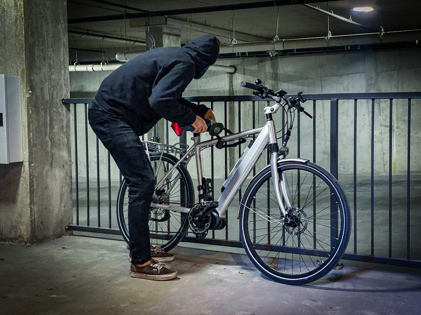 A thief uses an angle grinder to attempt to steal an electric bike.  Read on to learn more about e-bike security, locking techniques and theft prevention. 