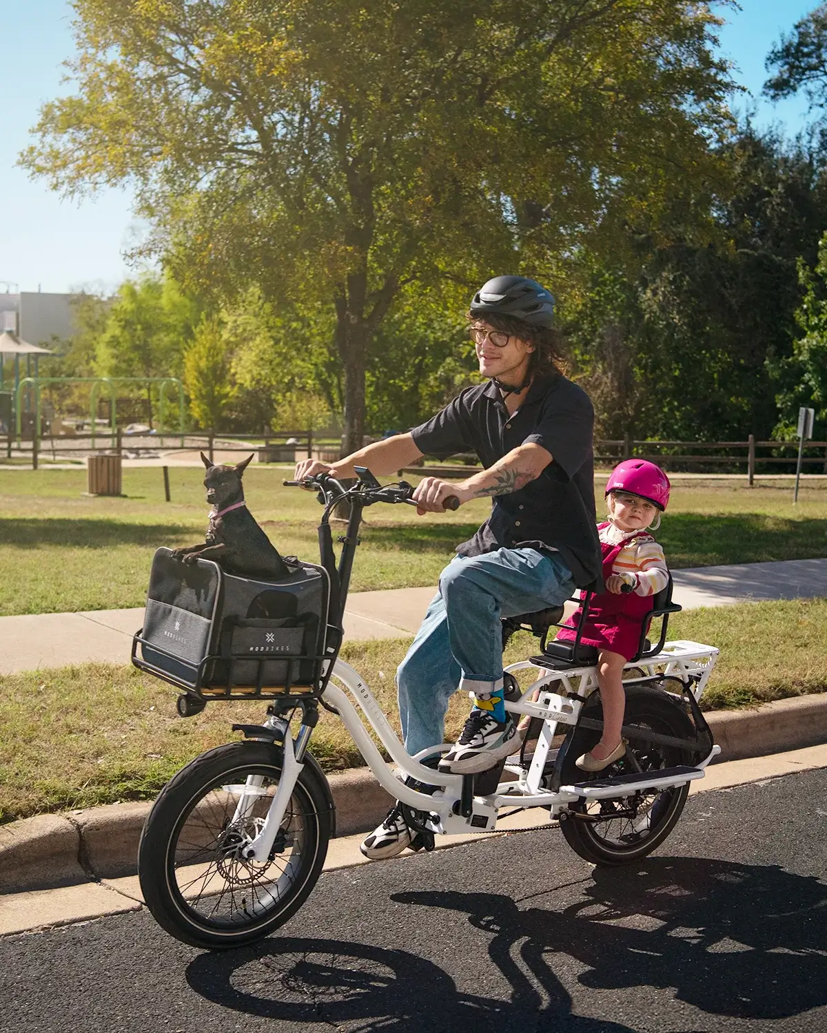 MOD CarGo 3 in action with a rider, child, and dog enjoying a sunny park outing.